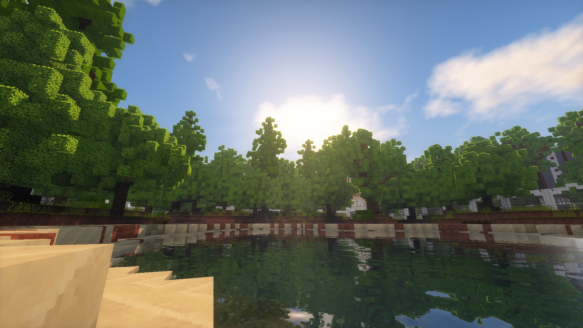 A screenshot within Minecraft of a pond surrounded by some trees. The area in which the screenshot was taken is from the Noxsquad Gameshow project.